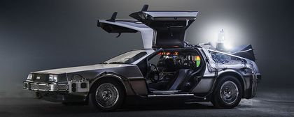 The DeLorean Time Machine from 'Back to the Future' with its wing doors opened and a glowing flux capacitor