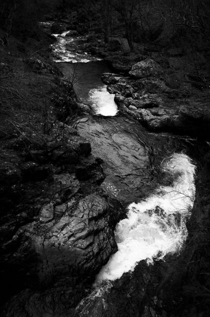 A river winding under a bridge